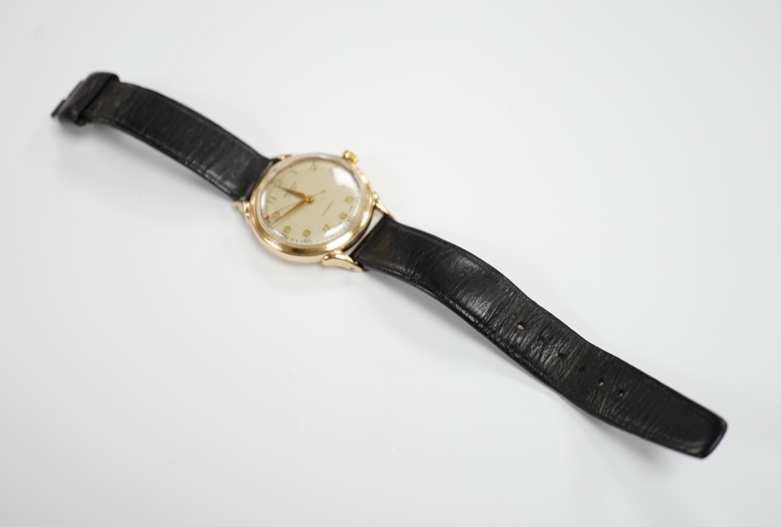 A gentleman's early 1950's 9ct gold J.W. Benson automatic wrist watch, case diameter 34mm, on associated leather strap, no buckle.